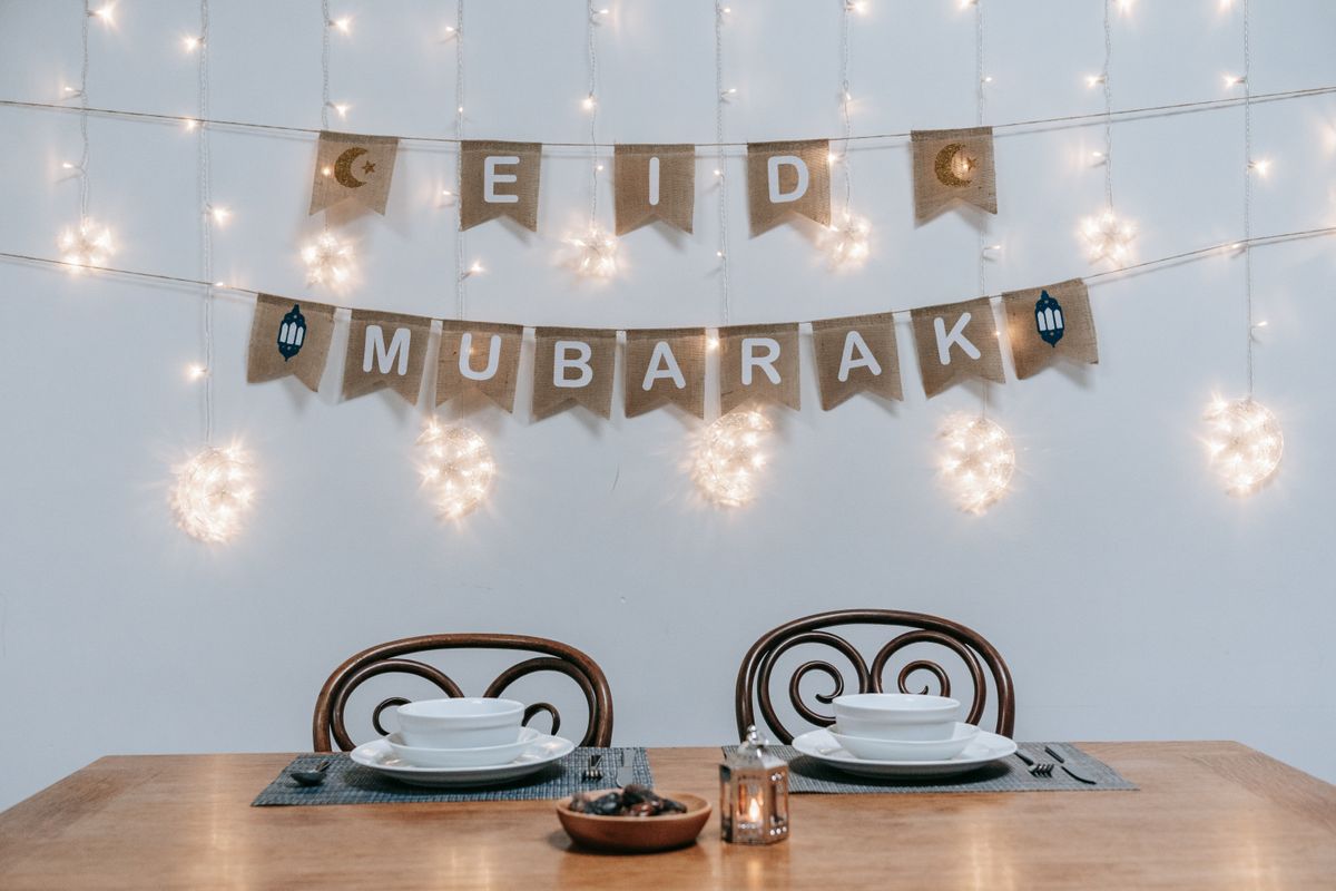 A table laid for Eid with dates, sweets and decorations