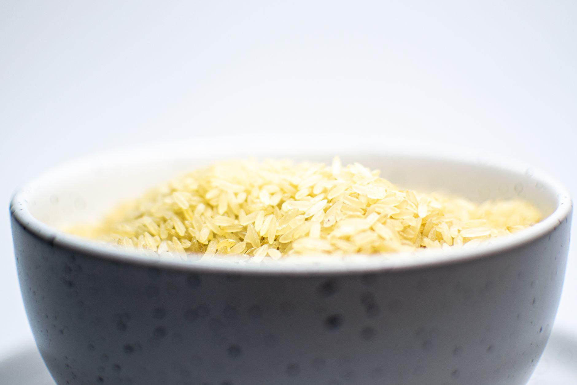 Uncooked rice in a bowl, a staple food used to feed those in need