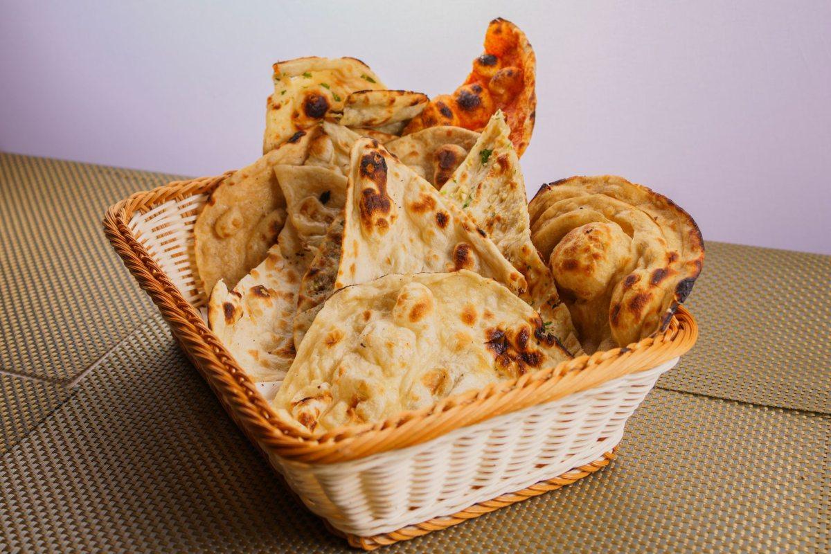Basket of fresh naan and flatbreads