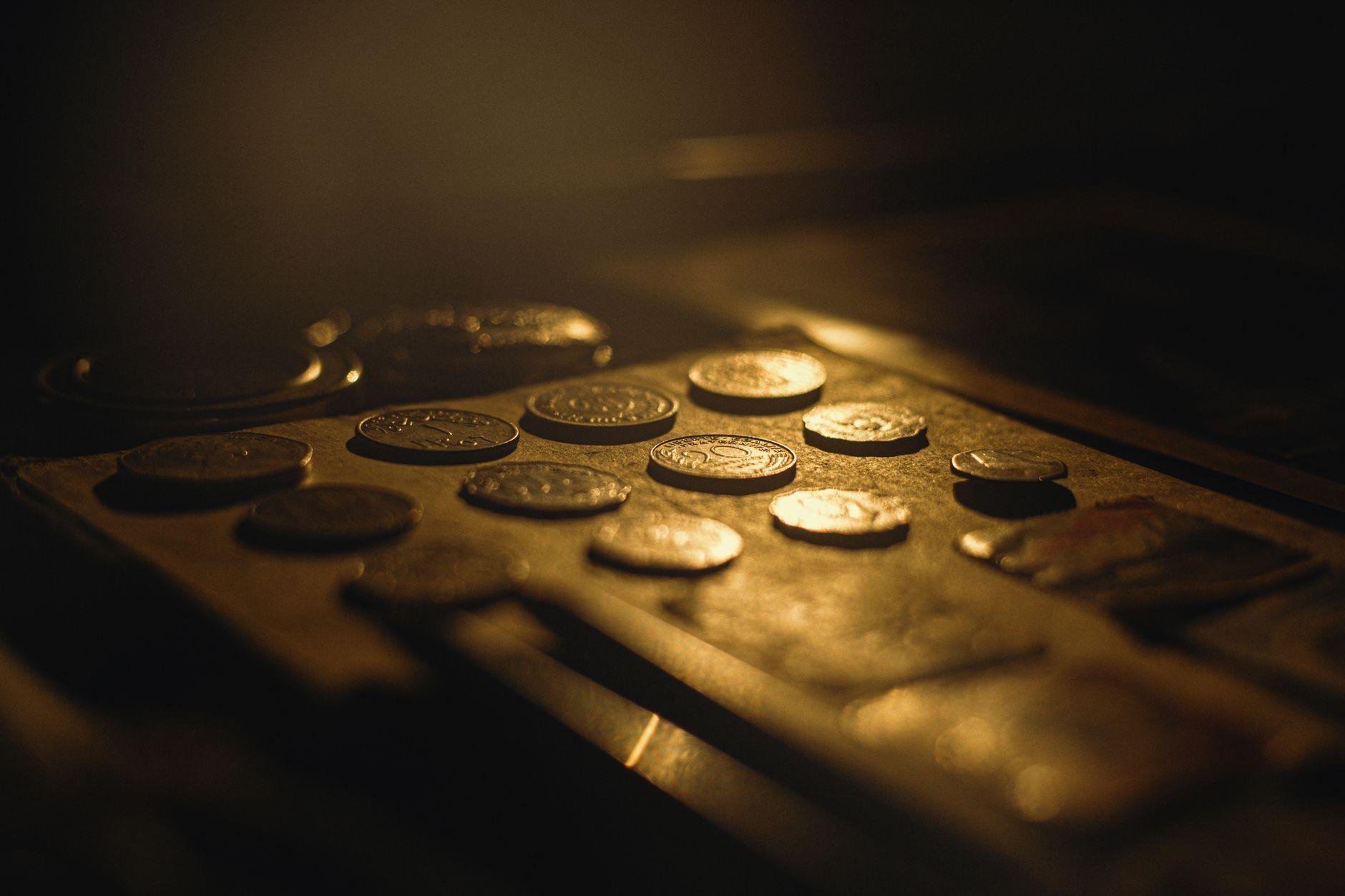 Coins in warm light, representing the 2.5% Zakat rate