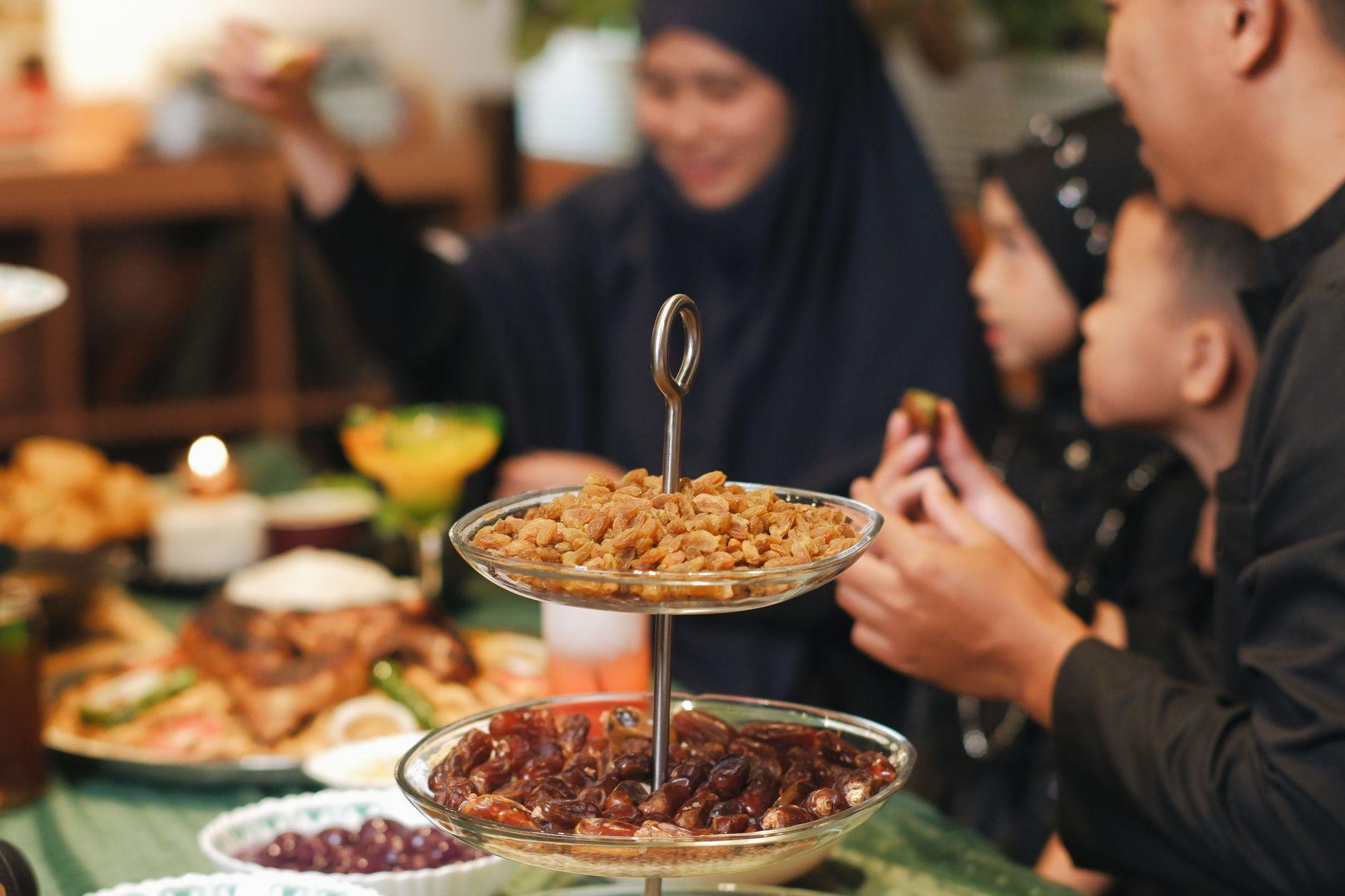 A family shares a meal together, dates in the foreground