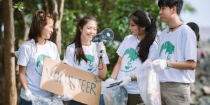 group-of-volunteers-hold-a-volunteer-sign-in-world-environment-day-event-volunteer-conservation-